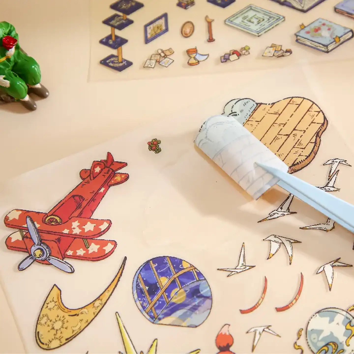 The Little Prince Scene Stickers | 1.0 Series – Star Museum from ASMR Stickers invites you to explore a dazzling world of celestial wonder. This 3D scene sticker depicts an enchanting museum filled with stellar artifacts and astronomical motifs. A magnificent golden star stands proudly at its center, surrounded by telescopes, vintage books, and intricately detailed globes. The Little Prince perches on a balcony, gazing at the cosmos, while another playful character pilots a tiny airplane, adding a spirit of adventure. Every element—from delicate star motifs to meticulously illustrated exhibits—blends fantasy with scientific marvel, creating an immersive display that captivates the imagination. Perfect for DIY sticker decoration, planner embellishments, and creative journaling, this high-quality, reusable sticker set is ideal for art lovers, ASMR enthusiasts, and collectors seeking unique design treasures. Elevate your projects with the magical allure of the Star Museum and experience a universe of creative inspiration unlike any other.